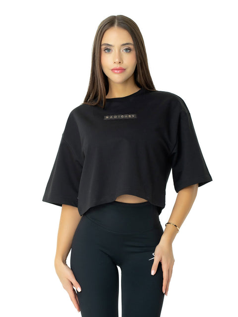 Short black T-shirt with leather emblem