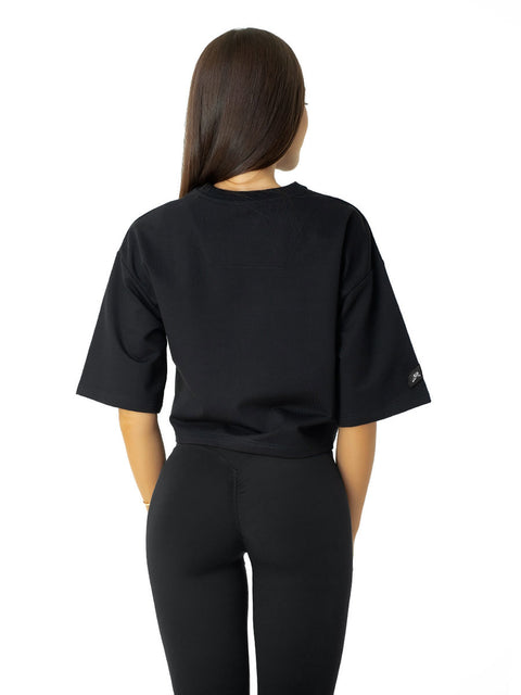 Short black T-shirt with leather emblem