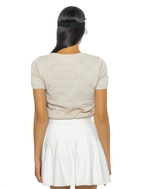 Short beige knitted blouse with all-over logos